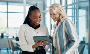 Two people looking at a tablet.