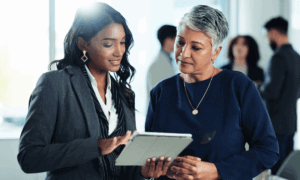 two people looking at a tablet